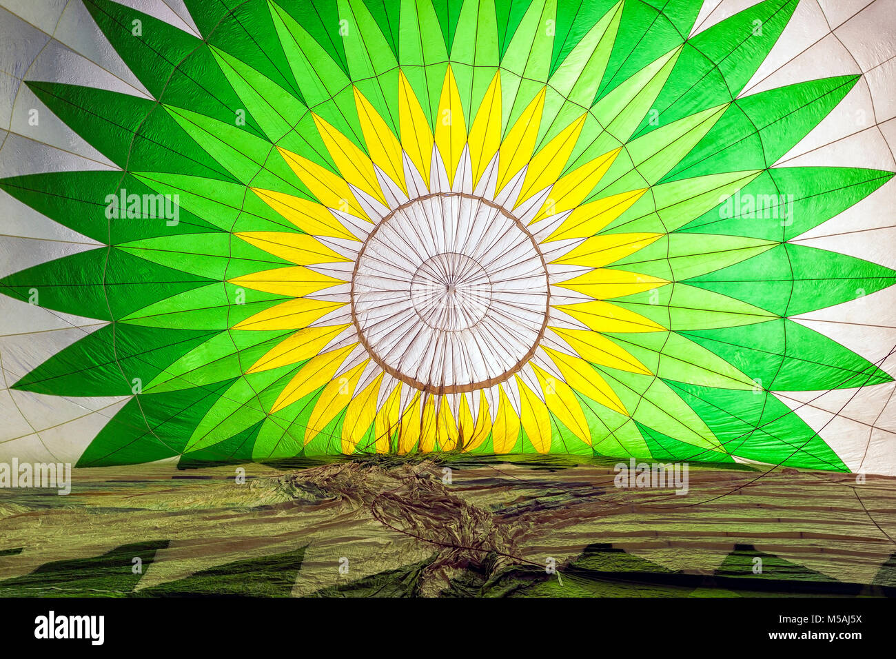 Inside a green and white patterned hot air balloon in preparation Stock Photo