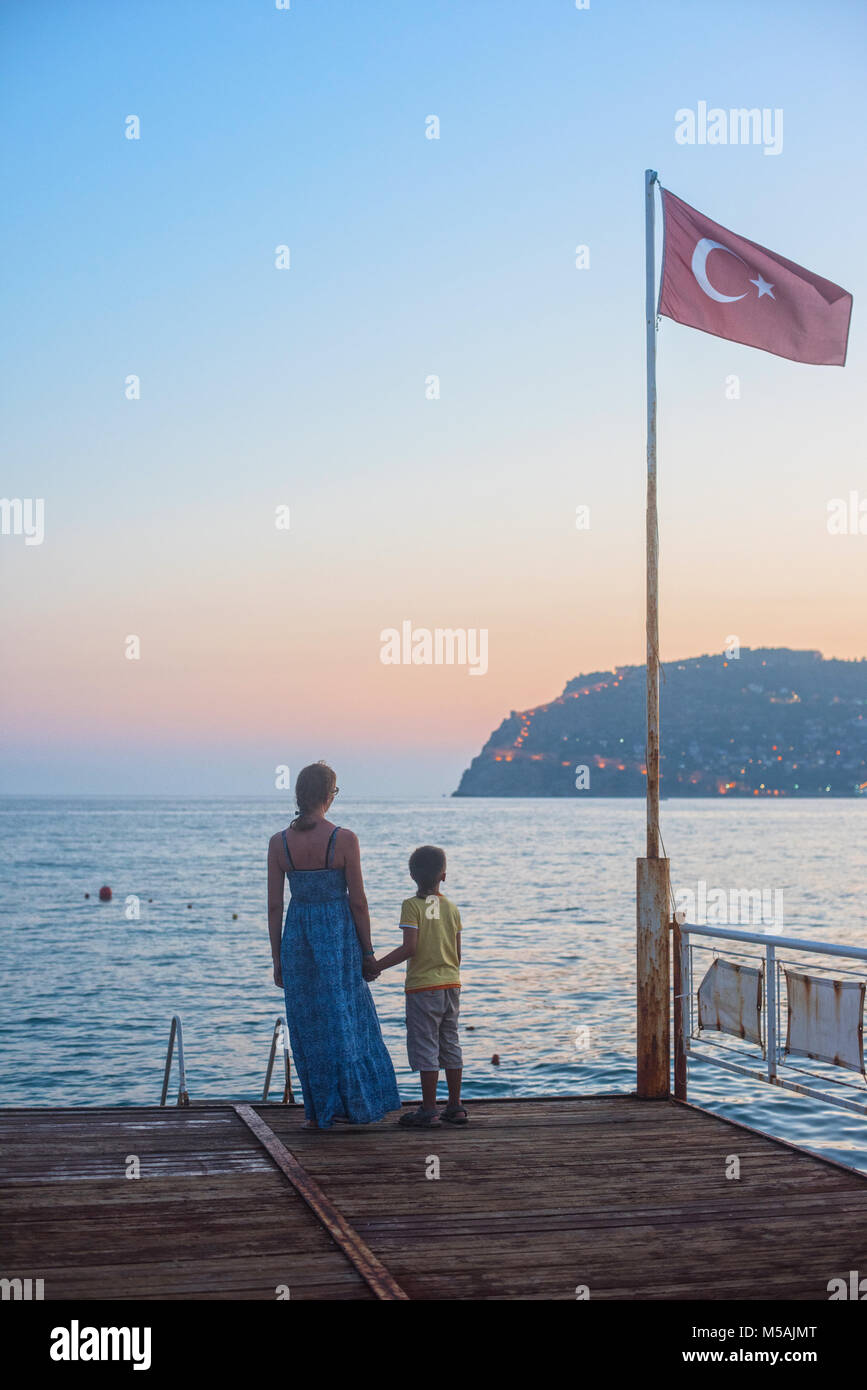 mother and son on the pier in the evening at Alania, Turkey Stock Photo