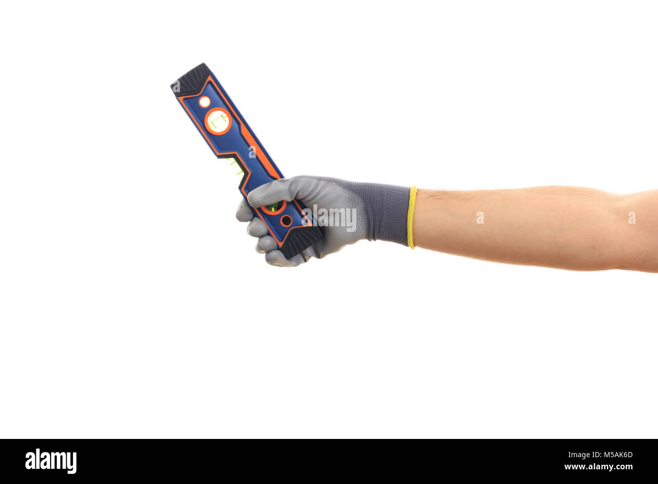 Spirit level on white background. Gloved hand holding a spirit level Stock Photo