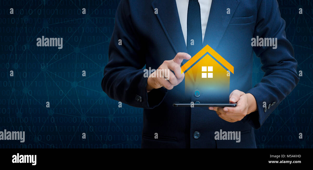 The house is in the hands of the business man  home icon or symbol Stock Photo