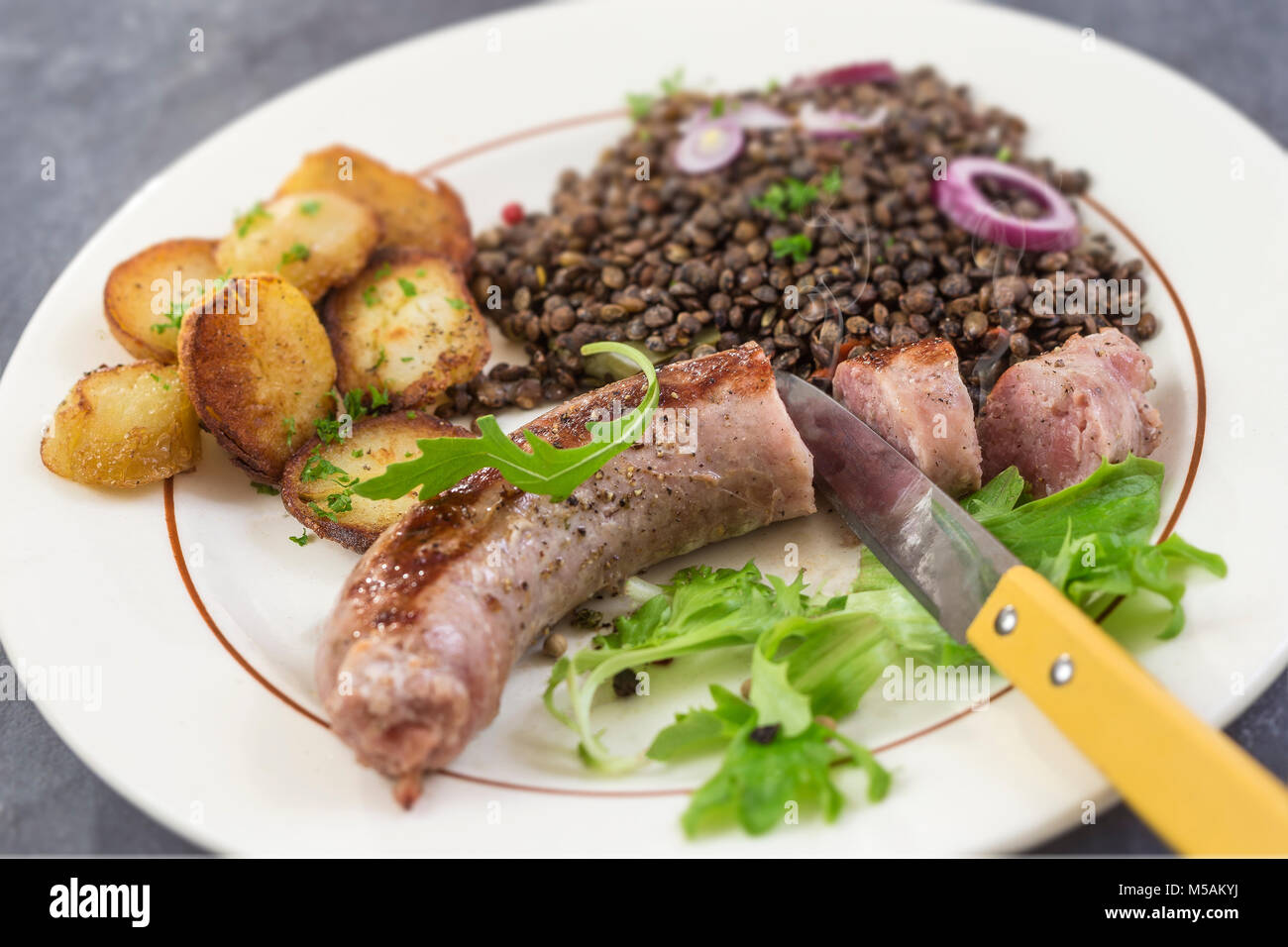 France Grilled Toulouse sausage with salad and lentils and potatoes