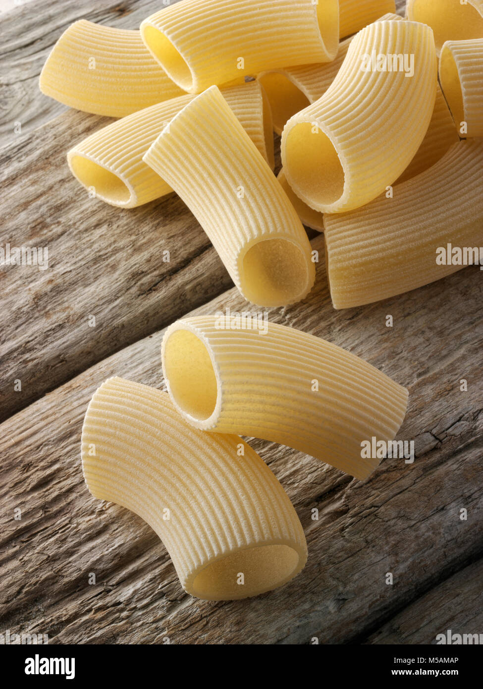 Traditional dried Italaian Rigatoni pasta close up in a rustic setting
