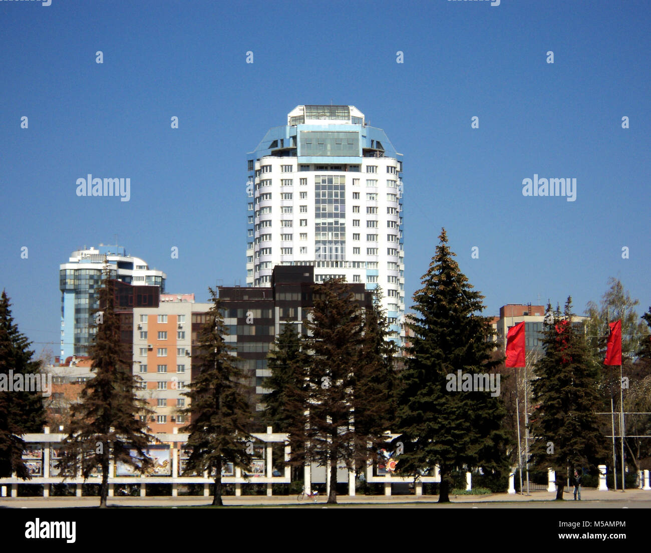 Landscape with white modern building with blue roof Stock Photo - Alamy