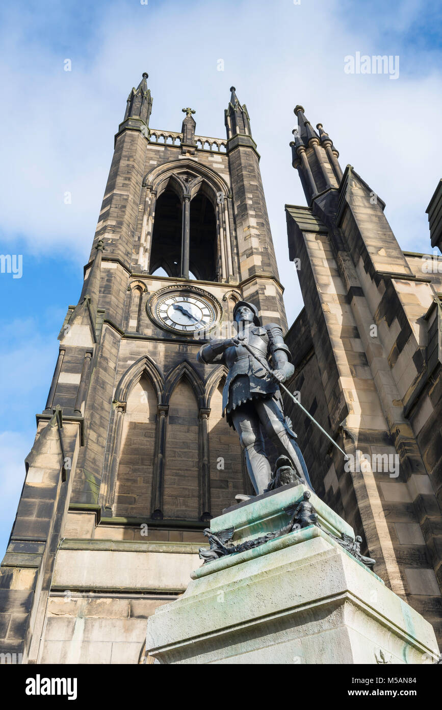 Victorian church, the tower of St Thomas The Martyr Church with its war memorial statue of St George in the foreground,city of Newcastle upon Tyne, UK Stock Photo