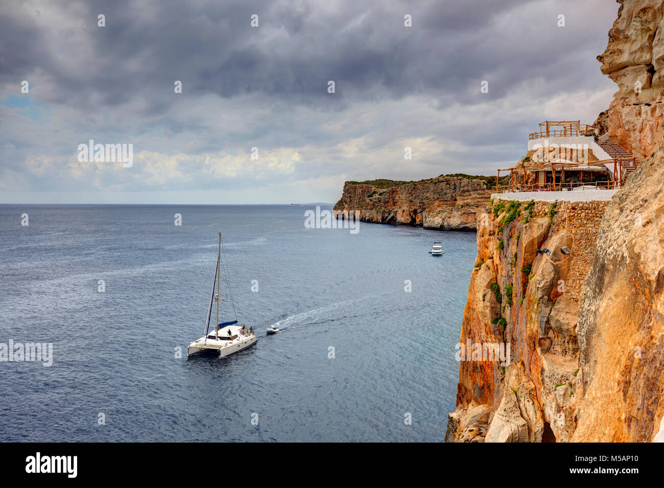 Cova d'en Xoroi bar, situated on a cliff on the south coast of Minorca, Spain Stock Photo