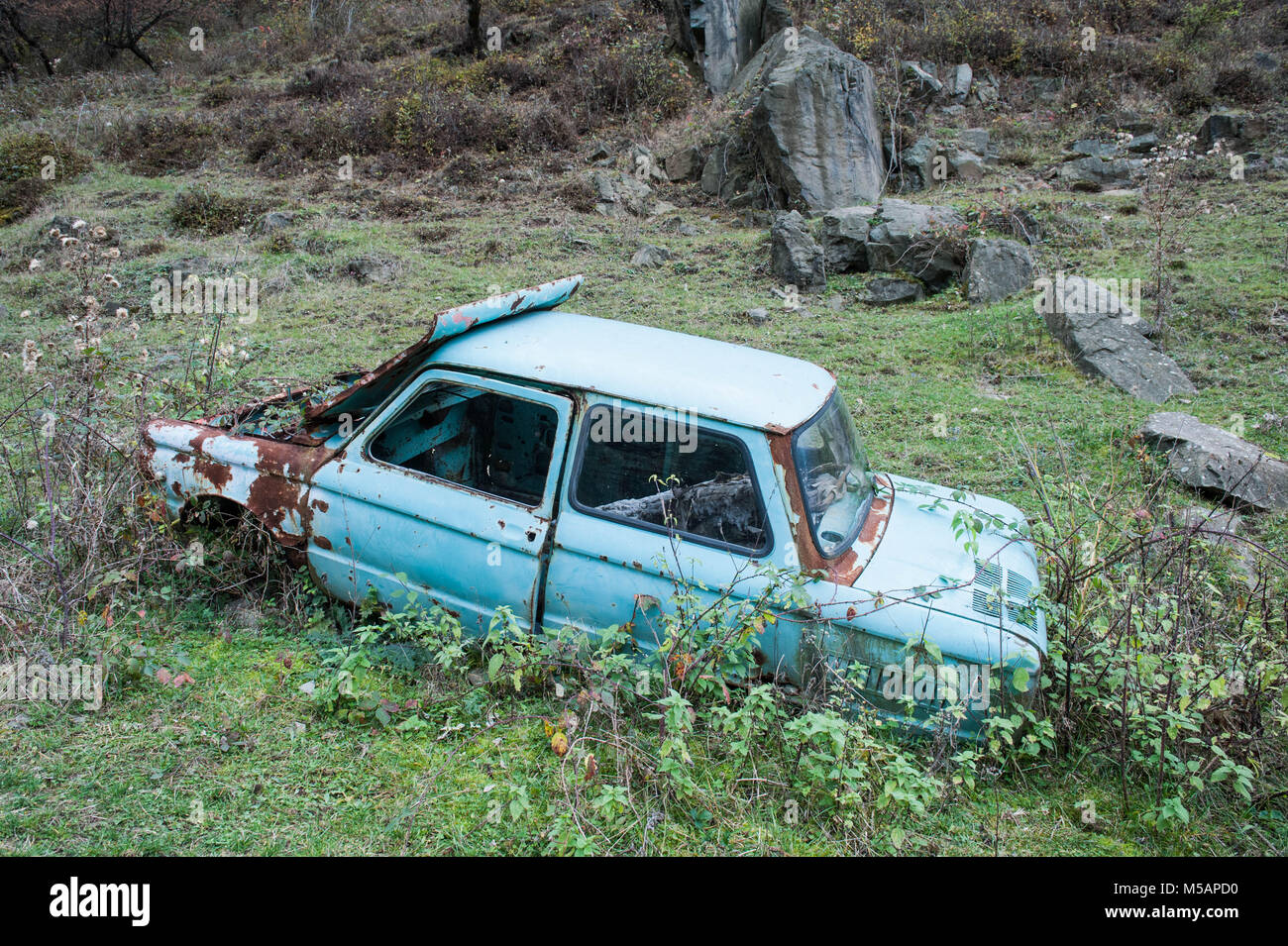Car wrecks are scattered around the environment on the way to the Haghartsin monastery Stock Photo