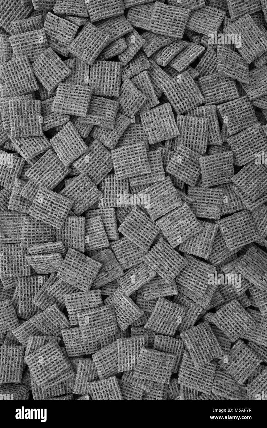 Malted shredded wheat biscuits breakfast cereal as an abstract background texture - monochrome processing Stock Photo