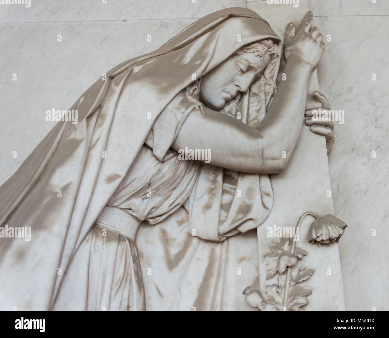 More than 100 hundred sculputure of a desolated woman, placed in the monumental cemetery Stock Photo
