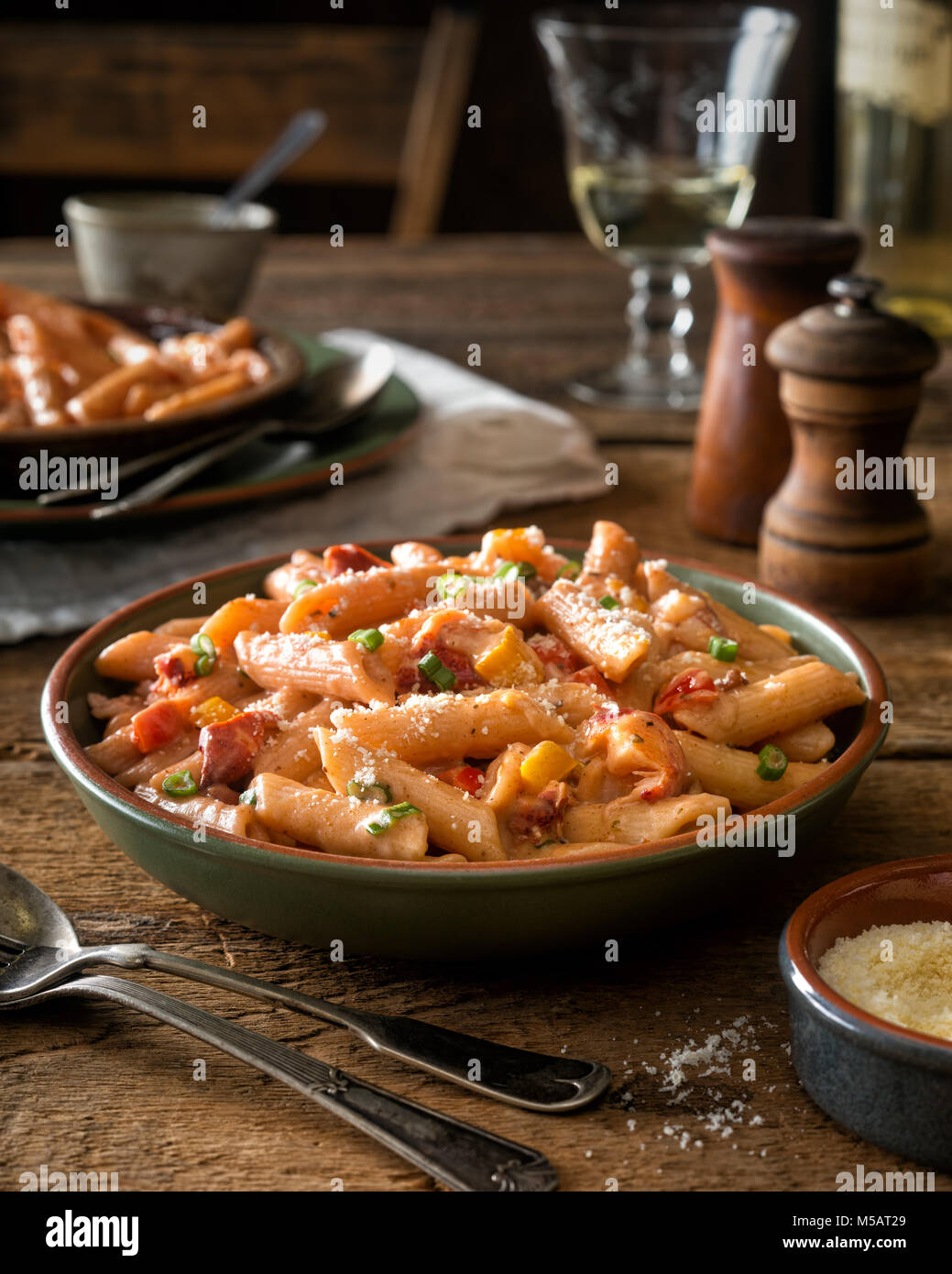 A bowl of delicious spicy cajun style pasta with lobster. Stock Photo