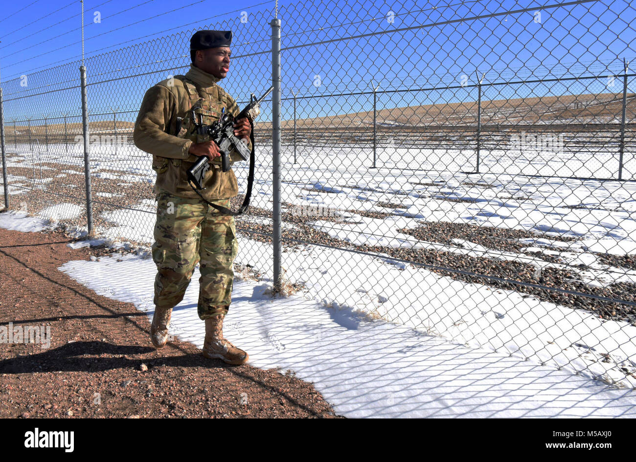 Senior Airman Erik Lewis, 90th Security Forces Squadron alarm monitor, patrols the fence in the weapons storage area at F.E Warren Air Force Base, Wyo., Jan. 26, 2018. Security forces members in the WSA are prepared to respond to threats at any time. (U.S. Air Force Stock Photo