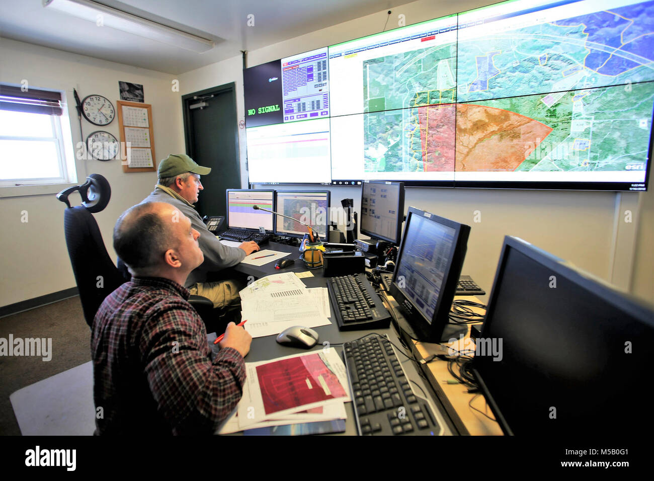 Range Control Technician Mark Confer and Brent Friedl with the Directorate of Plans, Training, Mobilization and Security works at the Fire Desk on Jan. 16, 2018, at Fort McCoy, Wis. The desk operates communications with units using the range complex as well as Range Maintenance and other personnel throughout 46,000 acres of training areas on Fort McCoy. (U.S. Army Stock Photo