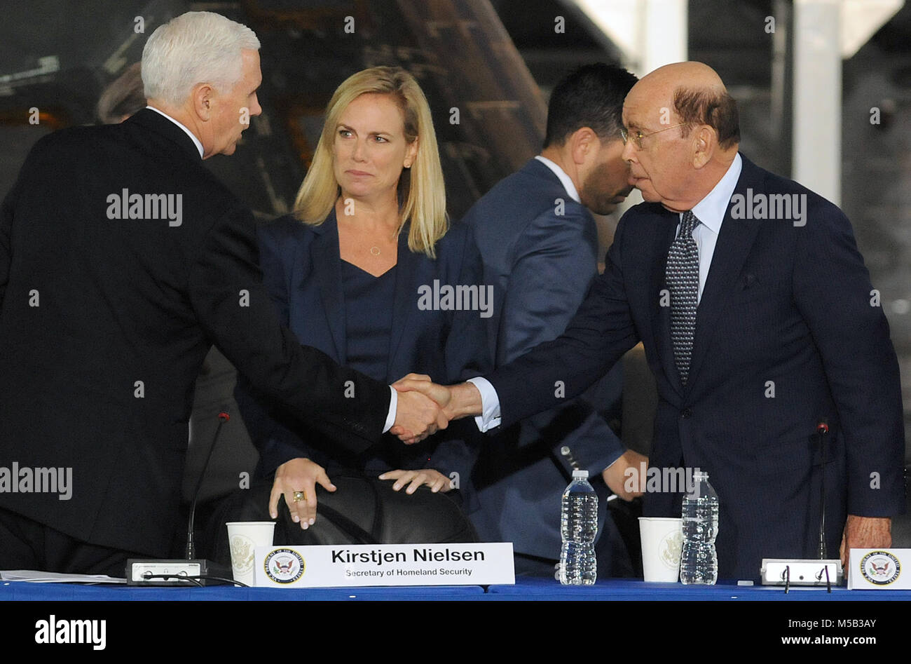 February 21, 2018 - Kennedy Space Center, Florida, United States -  U.S. Vice President Mike Pence (left) shakes hands with Secretary of Commerce Wilbur Ross as Secretary of Homeland Security Kirstjen Nielsen looks on at the conclusion of the second meeting of the National Space Council on February 21, 2018 at the Kennedy Space Center in Florida. The Trump administration re-established the council in June, 2017. (Paul Hennessy/Alamy) Stock Photo