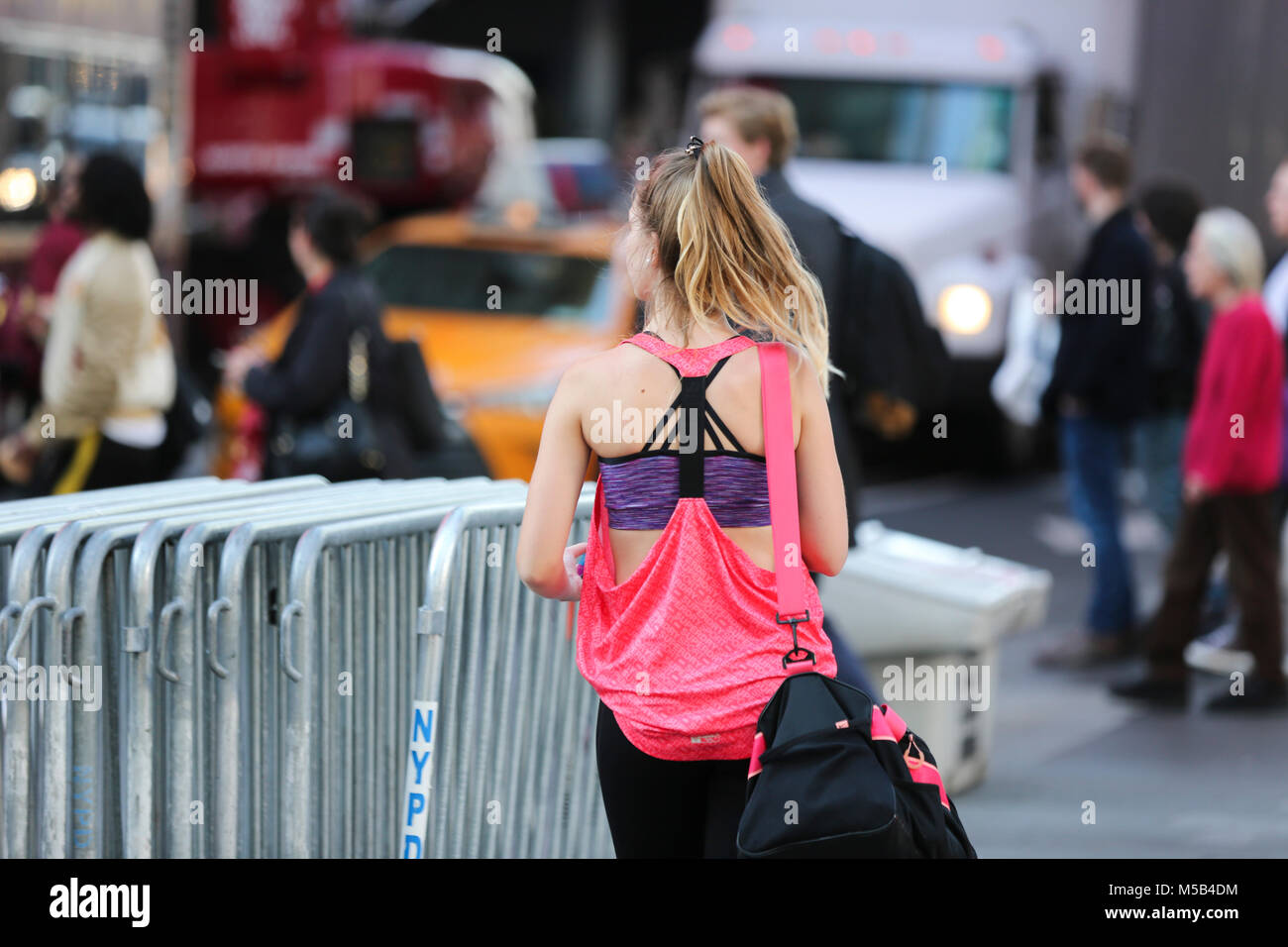 New York, USA. 21st Feb, 2018. A woman walks at Times Square in New