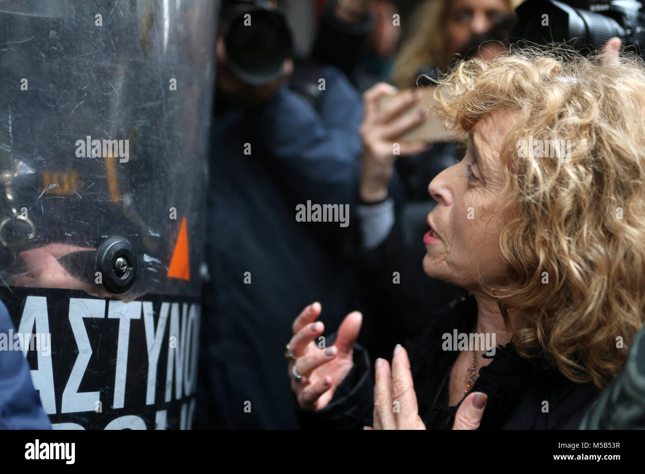 Athens, Greece. 21st Feb, 2018. A woman demonstrates against auctions of foreclosed properties outside a notary's office in Athens, Greece, on Feb. 21, 2018. Greek authorities will speed up the auctions of foreclosed properties which are conducted only electronically as of Wednesday, according to the new law voted in parliament last month. Over 1,700 auctions had been scheduled until Wednesday to take place in coming weeks via a special electronic platform set up in cooperation with the associations of notaries across Greece. Credit: Marios Lolos/Xinhua/Alamy Live News Stock Photo