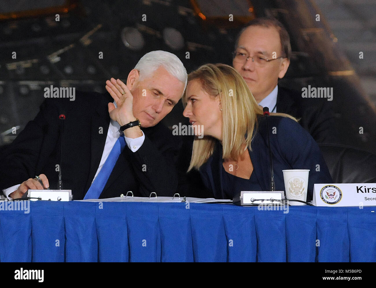 Kennedy Space Center, USA. February 21, 2018 - U.S. Vice President Mike Pence, chairman of the National Space Council, confers with Secretary of Homeland Security Kirstjen Nielsen during the group's second meeting. The Trump administration re-established the council in June, 2017. Credit: Paul Hennessy/Alamy Live News Stock Photo