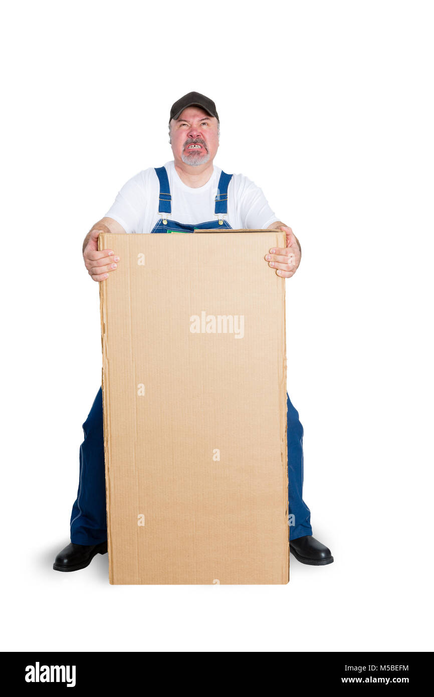 Delivery man standing behind large cardboard box against white background Stock Photo