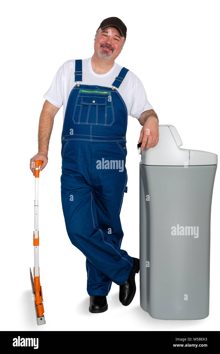 Proud confident water softener installer standing leaning on the new tank with a friendly happy smile isolated on white Stock Photo