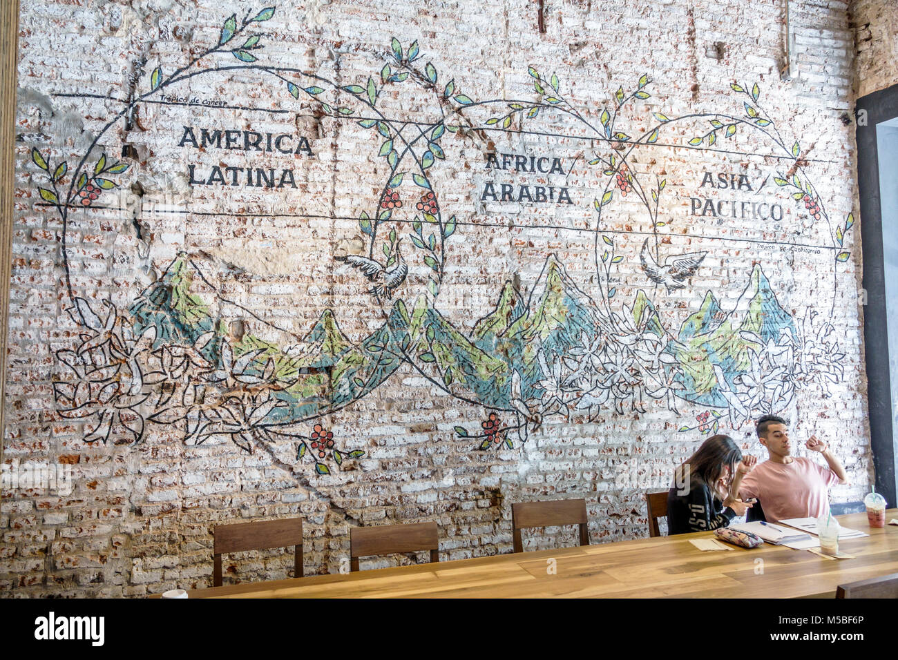 Buenos Aires Argentina,Galerias Pacifico,shopping mall,interior inside,Starbucks Coffee,cafe,coffeehouse,wall mural,exposed brick,table,adult adults m Stock Photo