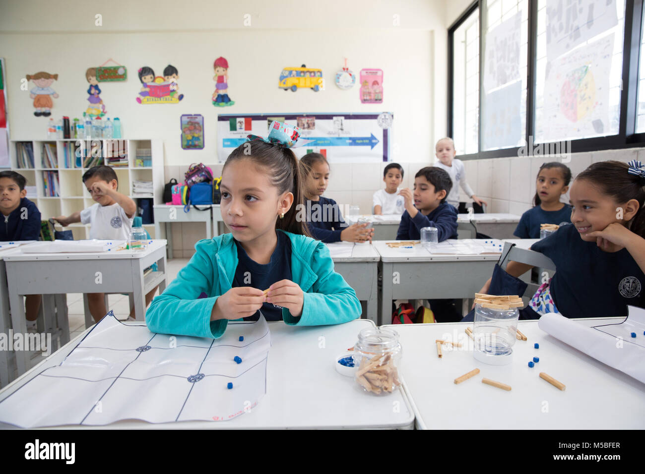 Mariana Parra Rosado attends a Mayan mathematics class at Escuela Modelo primary school in Merida, Yucatan, Mexico on December 19, 2017. Maya mathematics constituted the most sophisticated mathematical system ever developed in the Americas. The Maya counting system required only three symbols to form all their numbers: a dot representing one, a bar representing five, and a shell representing 20 or zero, depending on its placement. The Maya used a base 20 (vigesimal) numerical system, unlike our current base 10. (Photo by Bénédicte Desrus) Stock Photo