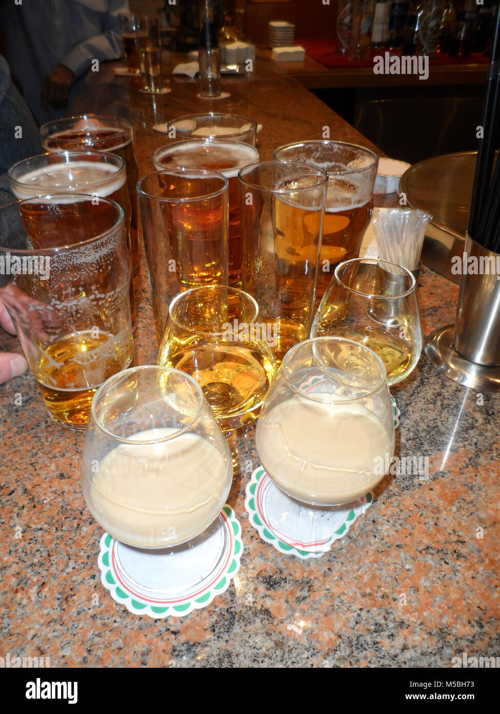 Assortment of alcoholic drinks on a bar including Lager, Whisky and Irish Cream Whiskey Stock