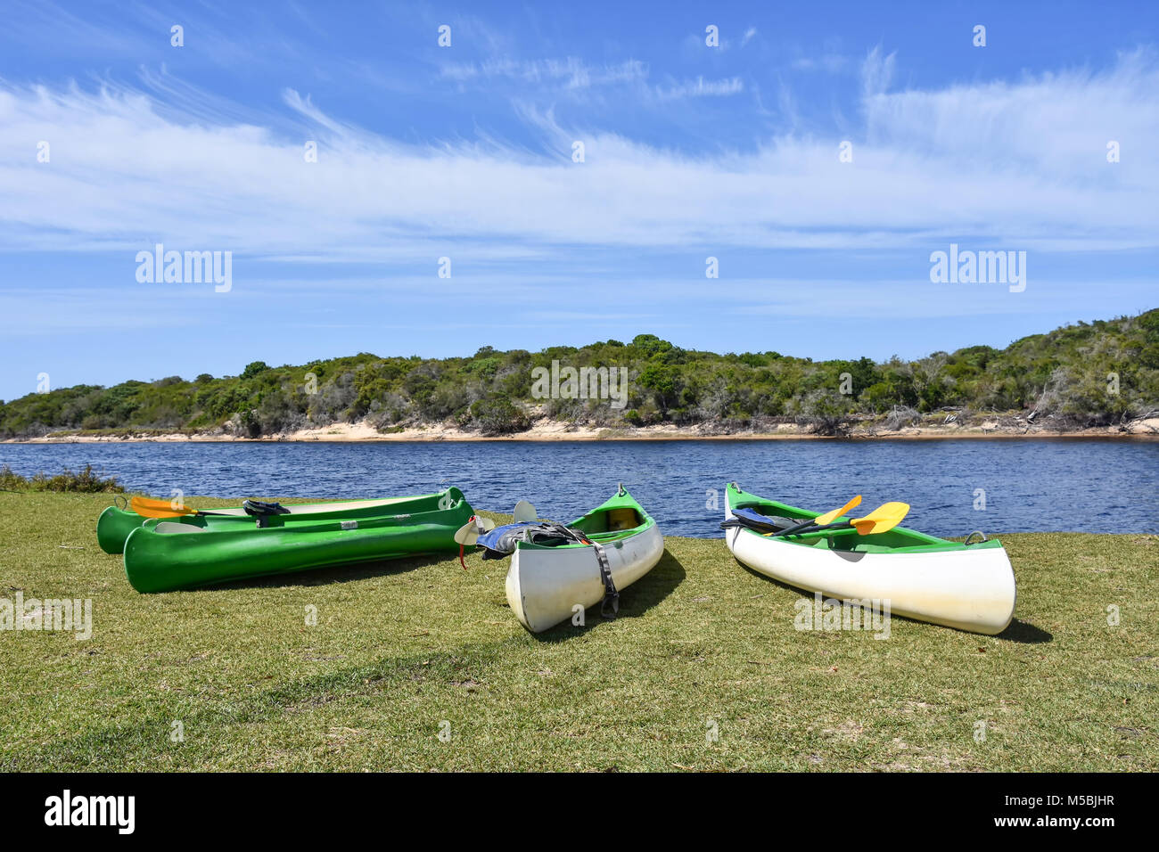 Several kayaks on a grass field near the lagoon of Goukamma near Knysna on the Garden Route in South Africa Stock Photo