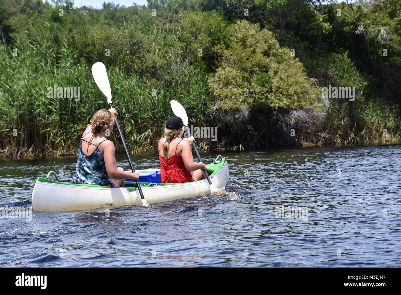Two female tourists Kayaking in a double kayak in Goukamma near Knysna on the Garden Route in South Africa Stock Photo