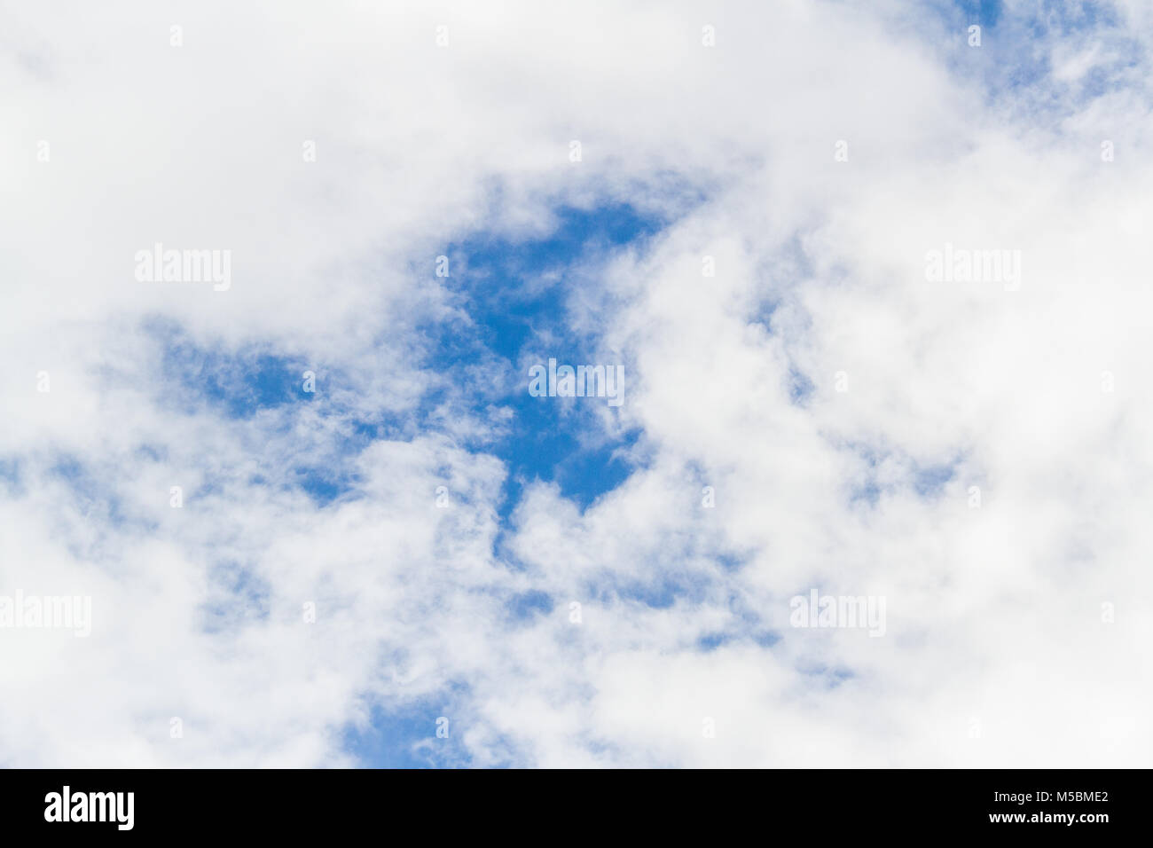 Blue sky background with white fluffy clouds Stock Photo - Alamy