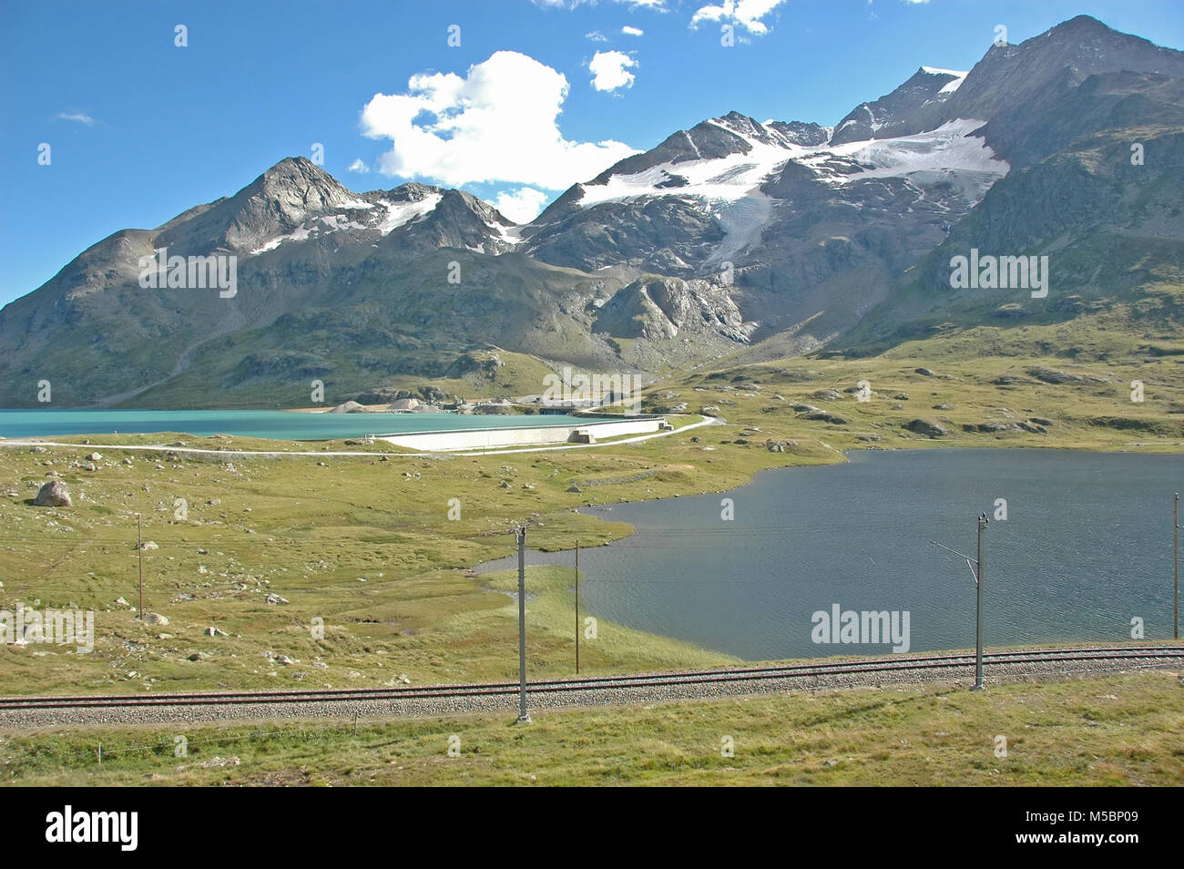 View from the Bernina Pass in southern Switzerland above St Moritz, with the railway lines of the Bernina Express which crosses the pass. And lakes Bi Stock Photo