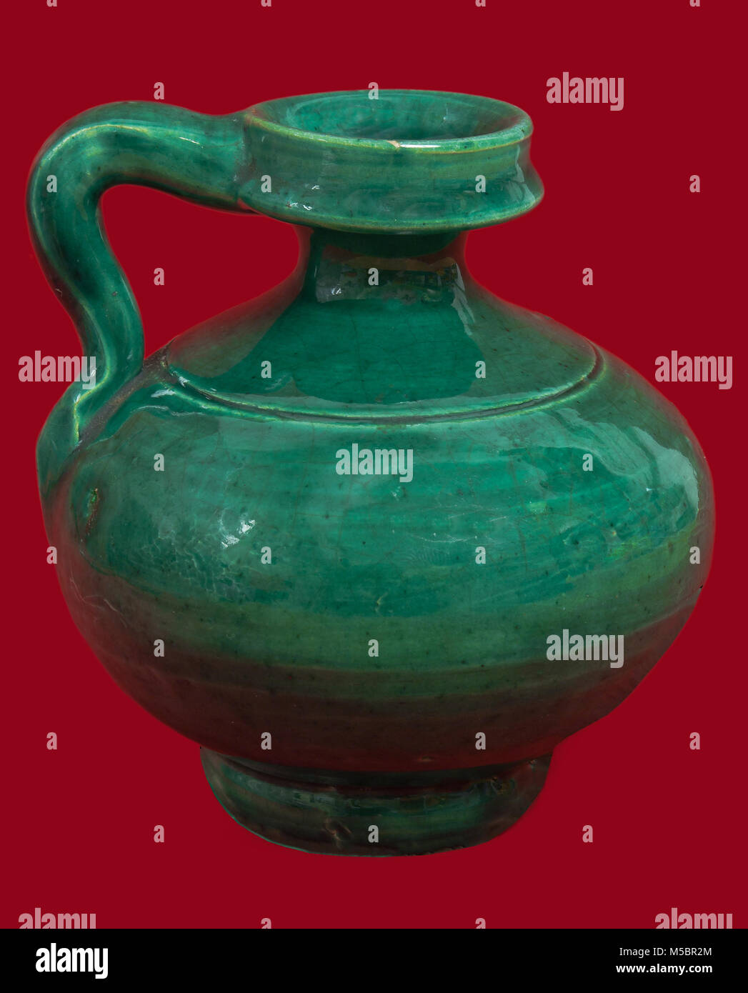 Perula, typical green glazed ceramic piece (small pear shaped vessel, used to keep the oil since the Roman, Ubeda, Jaen province, Region of Andalusia, Stock Photo