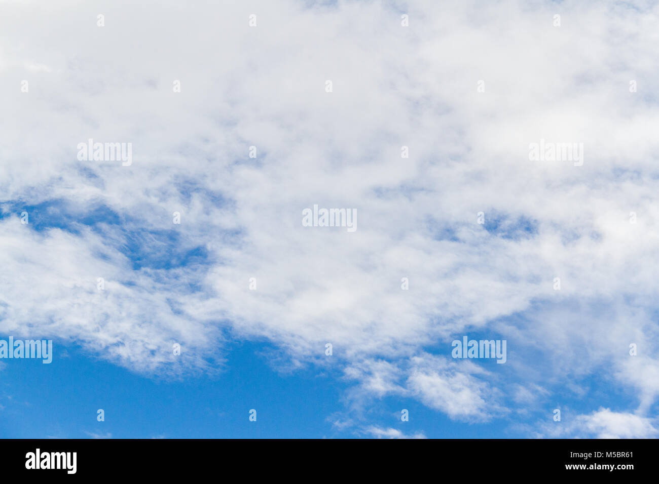 Blue sky background with white fluffy clouds Stock Photo - Alamy