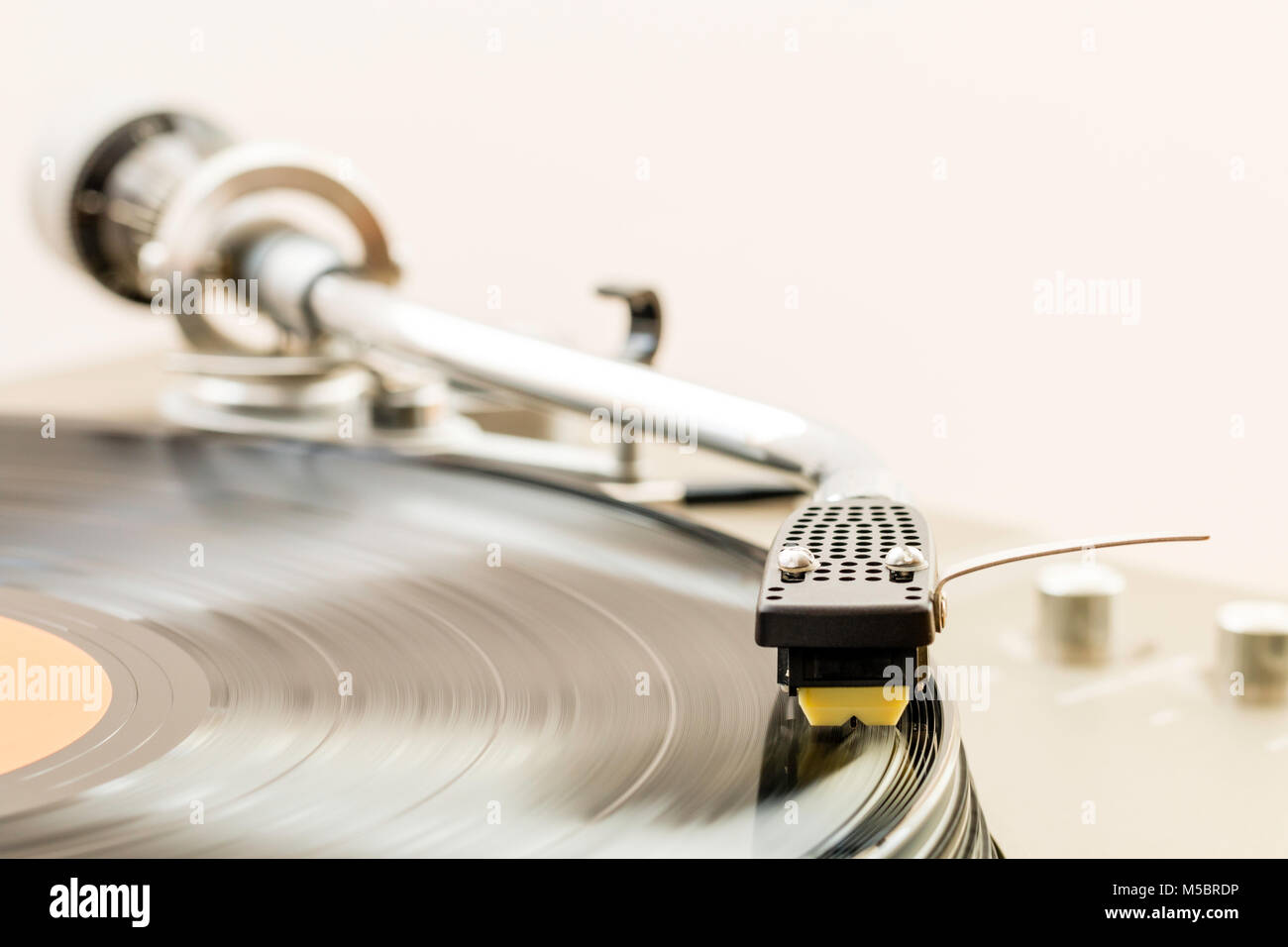 Record player deck, turntable, with 33 rpm, LP, record being played. Tone arm is an S-sharp. Stock Photo
