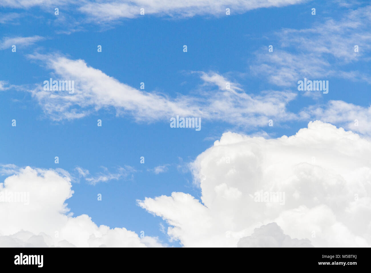 Blue sky background with white fluffy clouds Stock Photo - Alamy