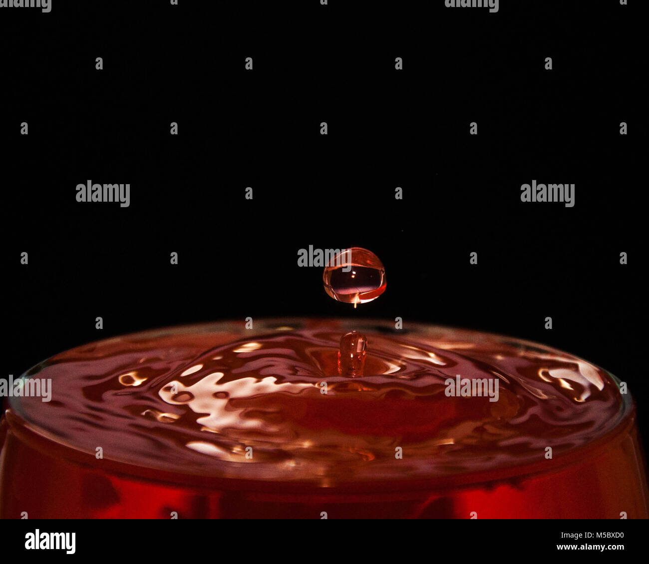 wine red drop splash black background Stock Photo