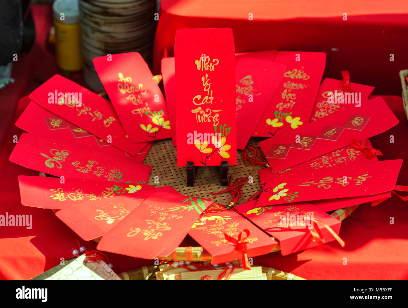 Red envelopes Lunar New Year Calligraphy decorated with text 'Merit, fortune, longevity' in Vietnamese means anyone receives money from envelope Stock Photo