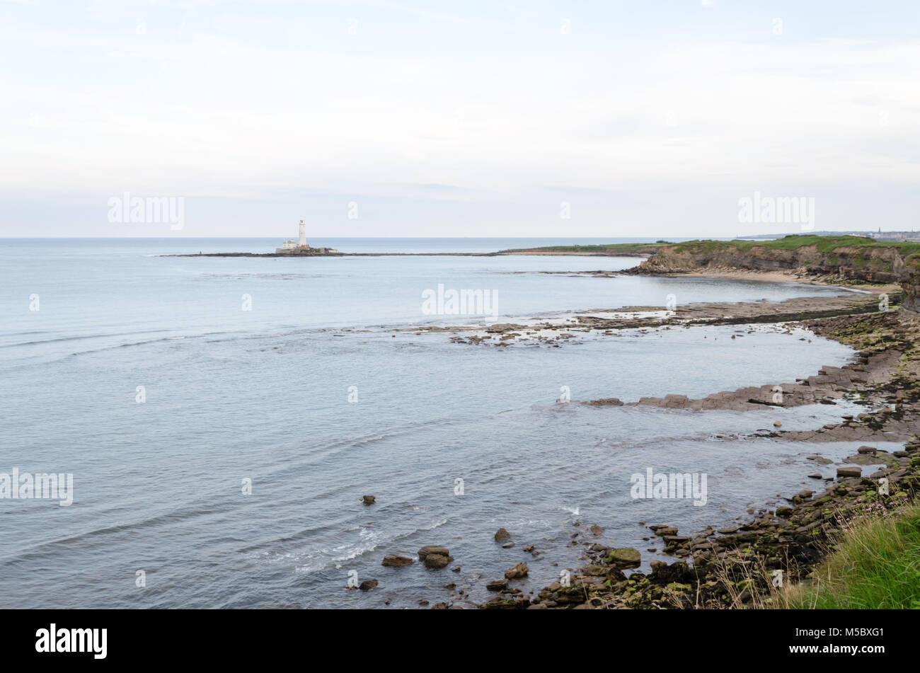 Sea View Towards Saint Mary's Island and Lighthouse from the Cliffs at Collywell Bay, Seaton Sluice, Northumberland Stock Photo
