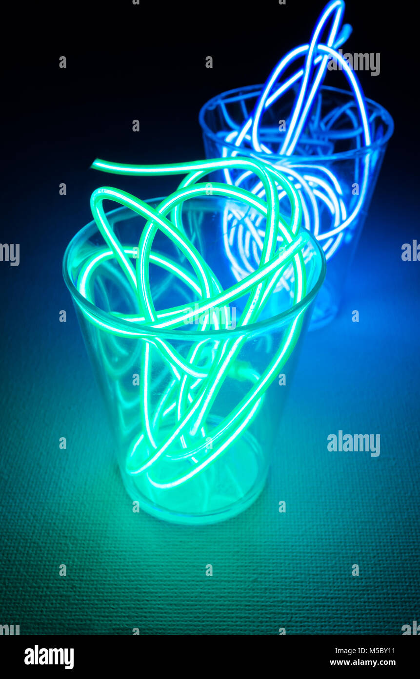 A Studio Still-life Photograph of Two Shot Glasses with Blue and Green Coloured Neon Lighting Stock Photo