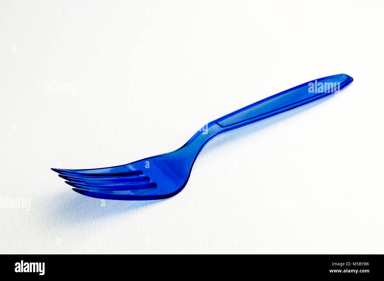 A Studio Photograph of a Blue Plastic Fork Stock Photo