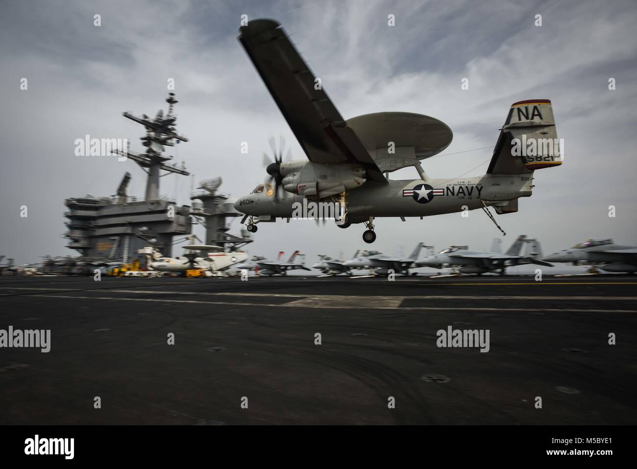 180221-N-VN584-1671 ARABIAN GULF (Feb. 21, 2018) An E-2C Hawkeye, assigned to the Sunkings of Carrier Airborne Early Warning Squadron (VAW) 116, approaches the flight deck of the aircraft carrier USS Theodore Roosevelt (CVN 71). Theodore Roosevelt and its carrier strike group are deployed to the U.S. 5th Fleet area of operations in support of maritime security operations to reassure allies and partners and preserve the freedom of navigation and the free flow of commerce in the region. (U.S. Navy photo by Mass Communication Specialist 3rd Class Alex Corona/Released) Stock Photo