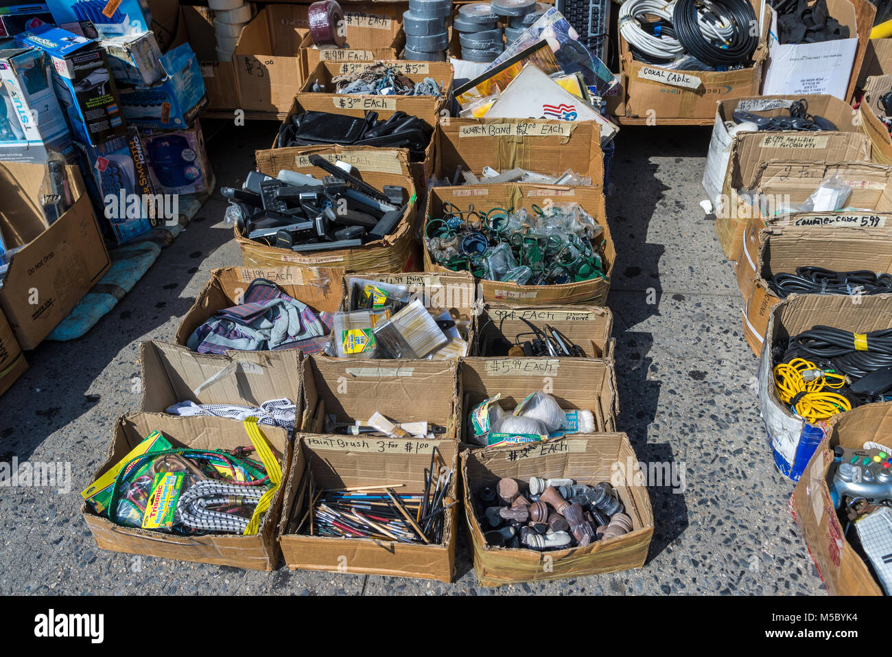 New York, NY 7 July 2014 - Miscellaneous items in cardboard boxes offered for sale on the sidewalk on Canal Street. ©Stacy Walsh Rosenstock/Alamy Stock Photo