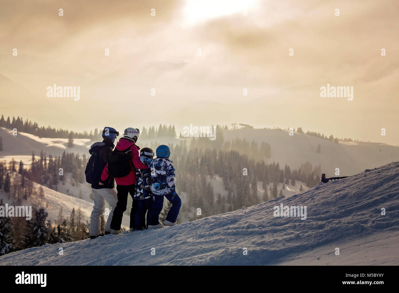 Cute girl skier skiing with family on mountain Stock Photo - Alamy