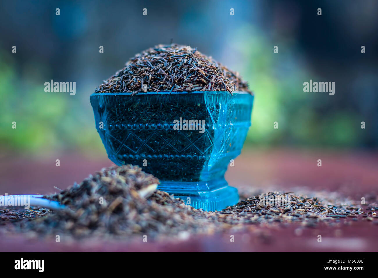 Close up of Shahjerra,Carum carvi,Caraway seeds in a bowl on wooden surface. Stock Photo
