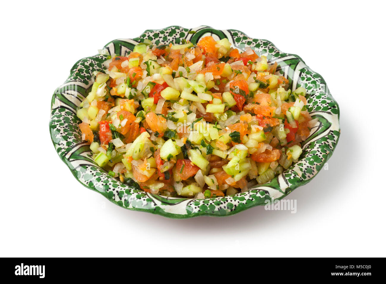 Moroccan dish with mixed vegetable salad and herbs isolated on white