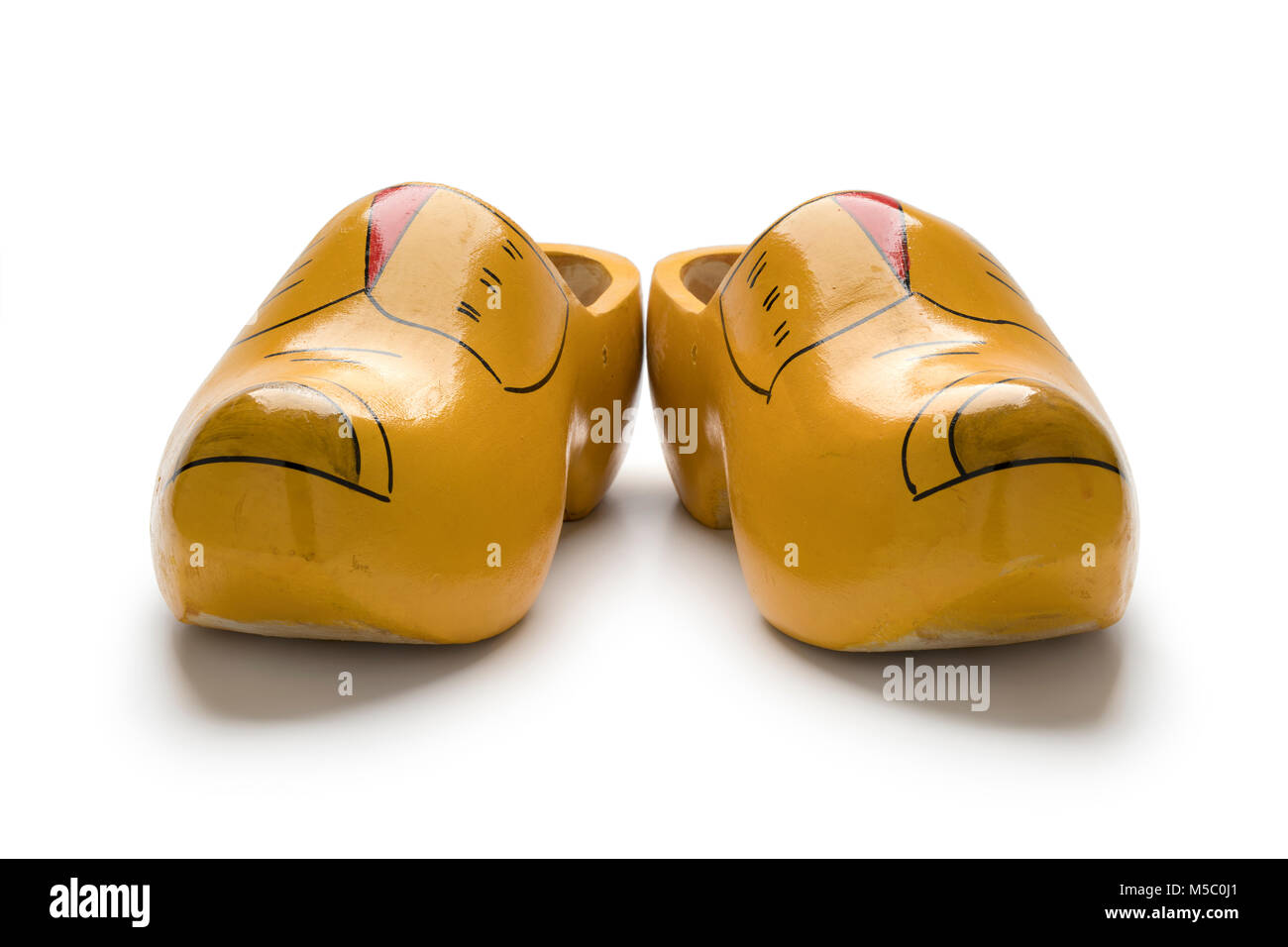 Pair of traditional yellow Dutch wooden shoes on white background Stock Photo