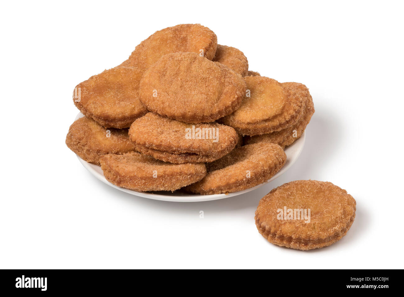 Dish with  sugared fried apple fritters or appelflappen, a traditional Dutch pastry for New Year's Eve , isolated on white background Stock Photo