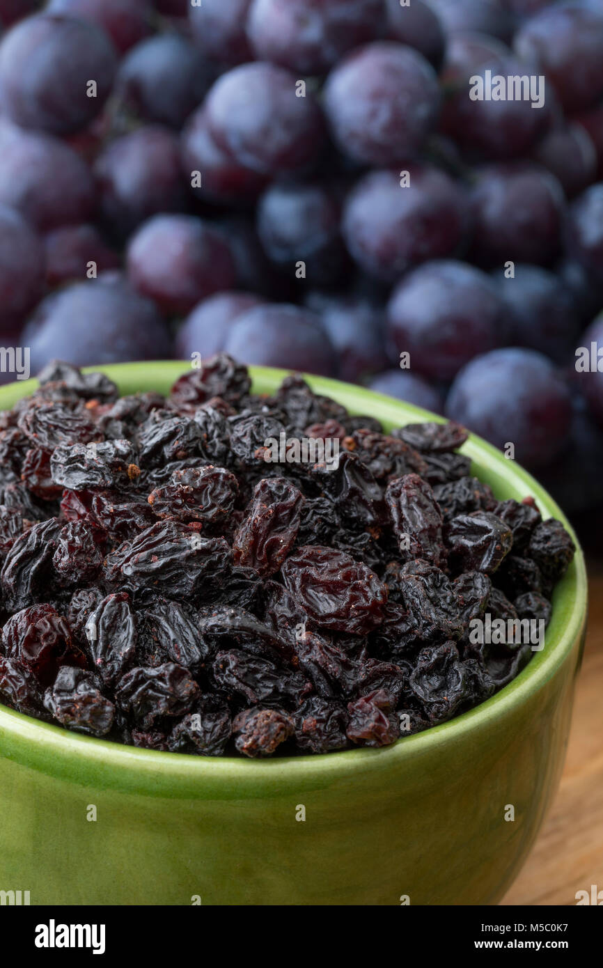 Bowl with dried currants and sweet, seedless grapes in the background Stock Photo Alamy