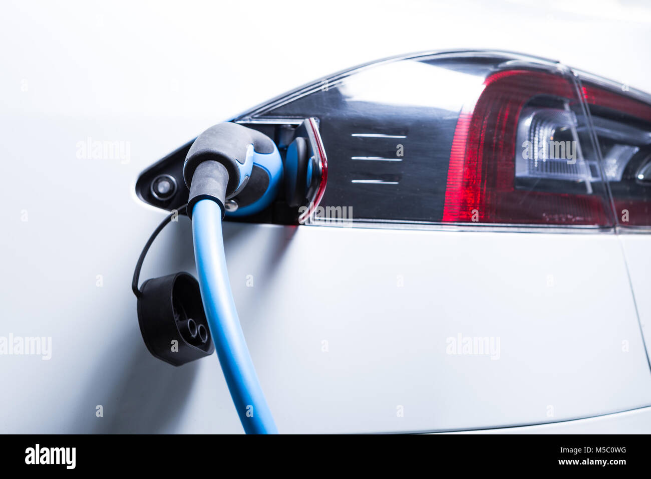 Full electric Tesla car charging picture with plugin connector as