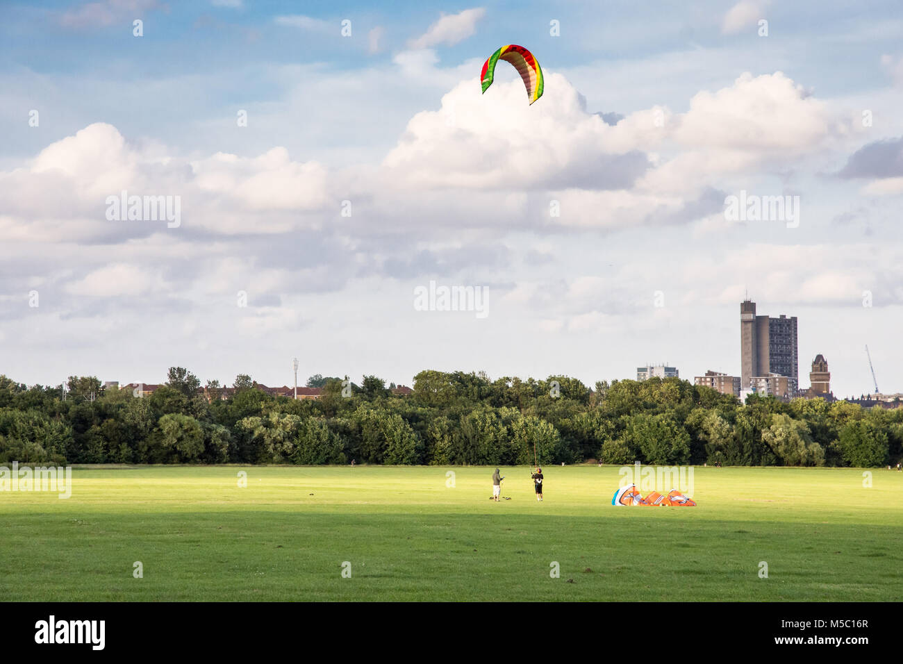 London, England July 10, 2016 Two people fly a large kite on