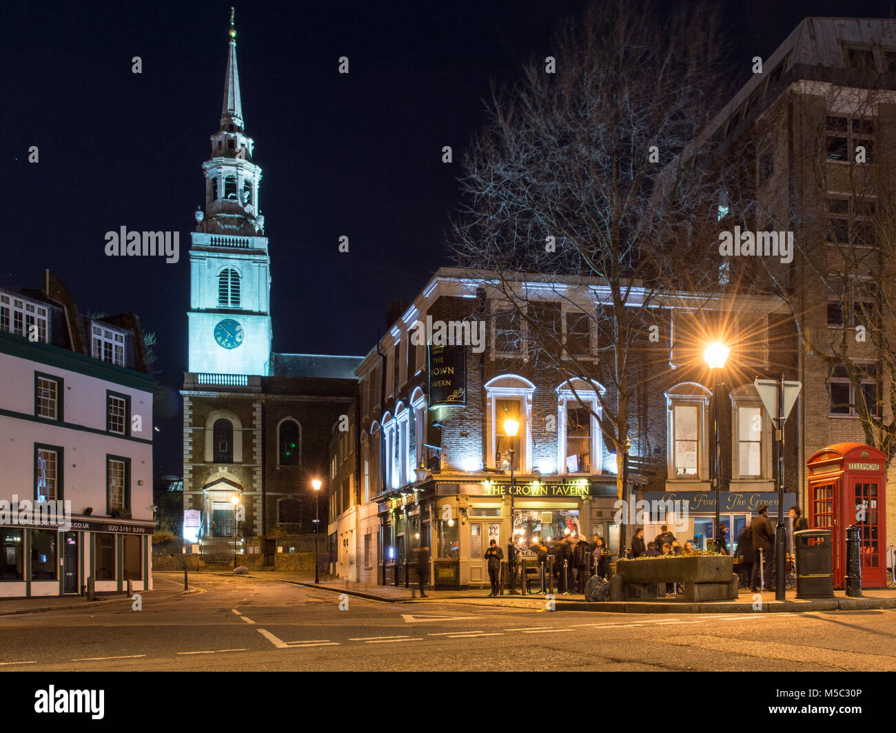 London, England, UK - February 9, 2018: The spire of St James's Church is lit up at night on Clerkenwell Green in central London. Stock Photo