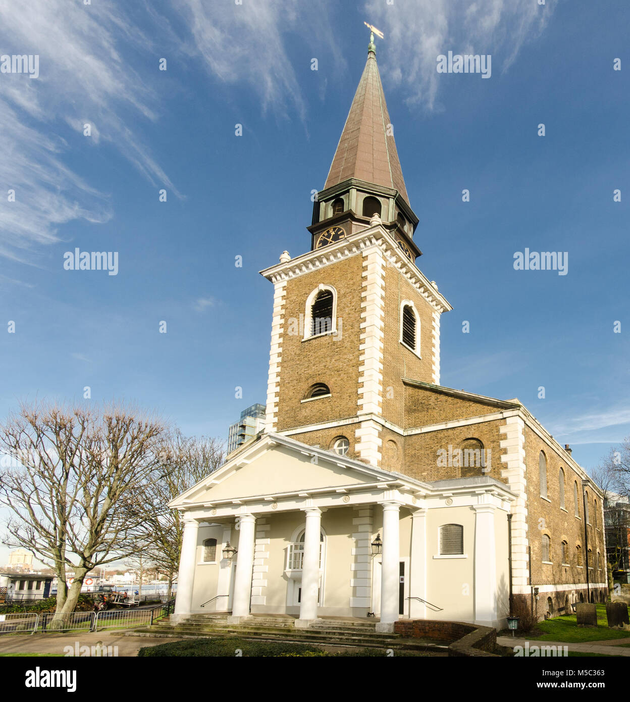 London, England, UK - January 14, 2014: Sun shines on the west front and spire of St Mary's Church, Battersea, on the Thames Path in west London. Stock Photo