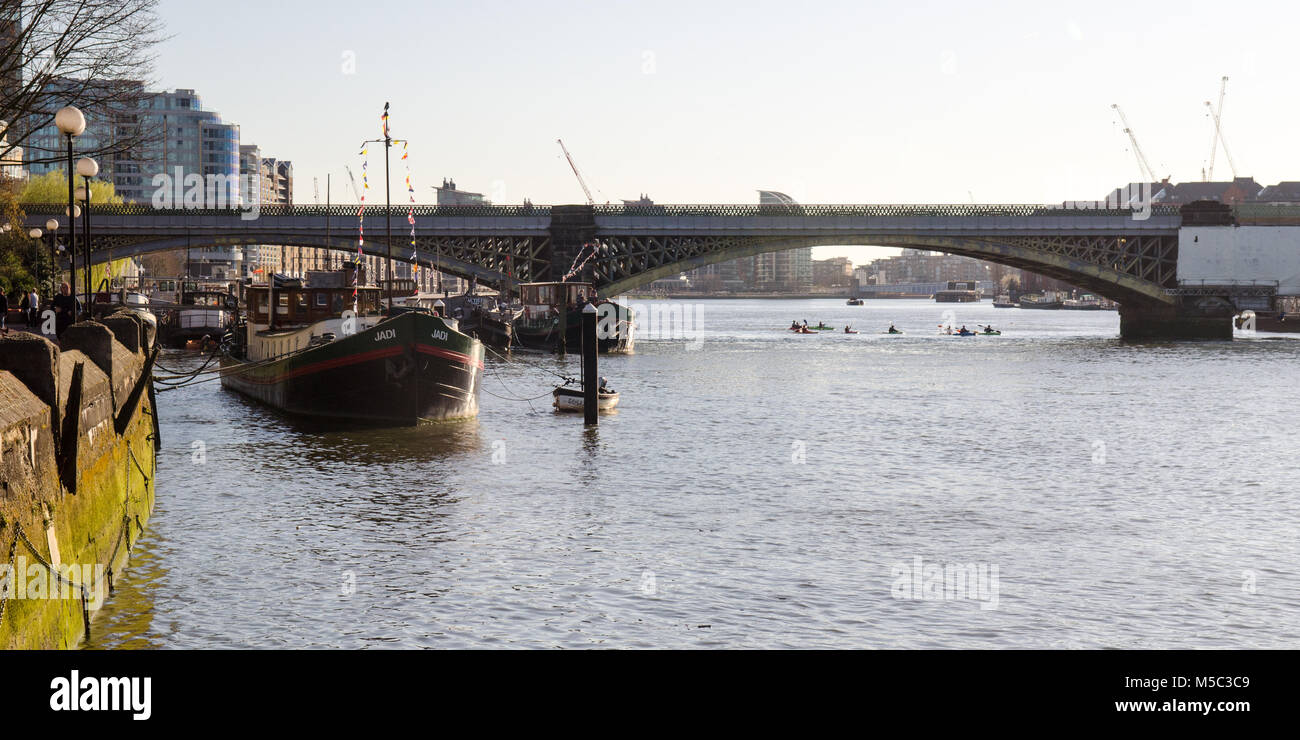 London, England, UK - March 16, 2014: A group of Kayakers pass under the London Overground railway bridge at Battersea Riverside on the River Thames i Stock Photo